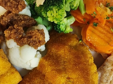 Breaded pork cutlet with vegetables and croquettes