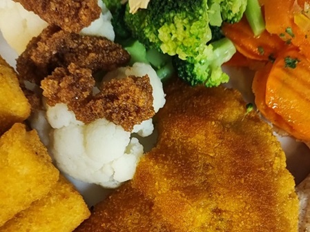Breaded pork cutlet with vegetables and croquettes